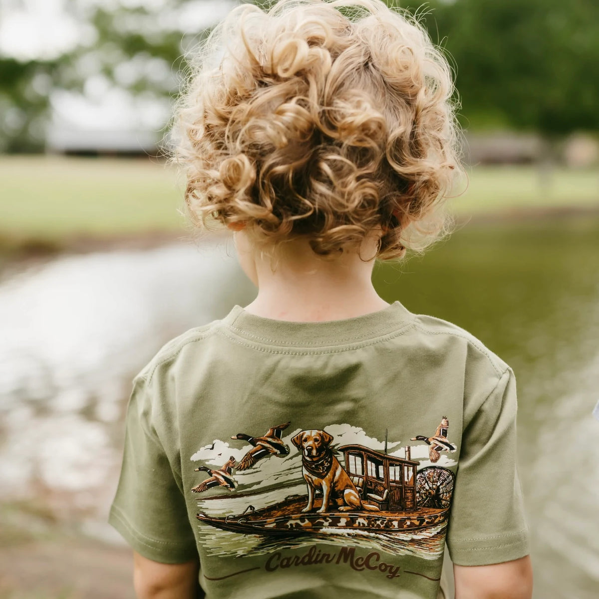 Close-up of the Duck Boat artwork on an olive Cardin McCoy tee.